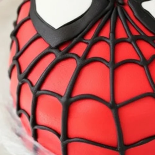 Gâteau Spiderman impressionnant: un gâteau détaillé en forme de tête de Spiderman, avec un glaçage rouge, une toile d'araignée noire et des yeux blancs distinctifs, idéal pour une fête d'anniversaire.